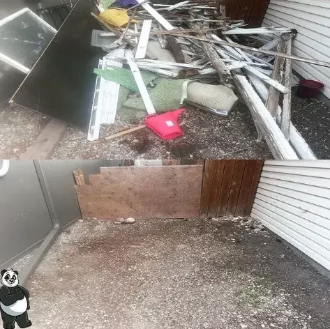Side yard stacked with torn-out fence boards and lumber, then cleared